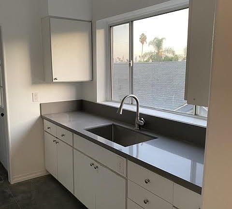 New kitchen with quartz counters large window providing great views of the LA Skyline