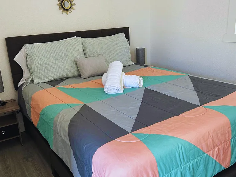 Room with decor pieces, towels and natural light window.