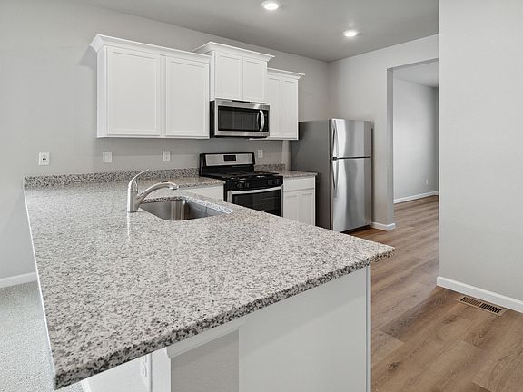 Upgraded kitchen with stunning cabinetry and sprawling countertops.