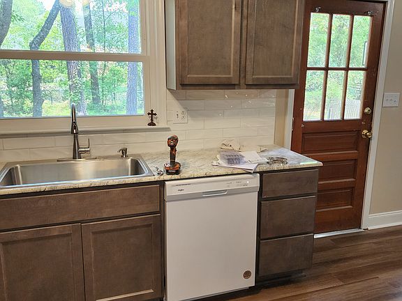 Kitchen sink and dishwasher. Misc on counter not included.