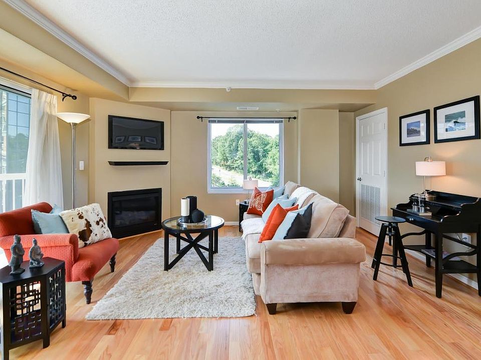 Living room with gas fireplace; sliding doors to large balcony