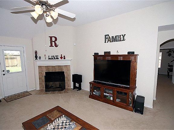 Cozy open living area with fireplace including gas logs, and plenty of space for a flat screen TV! O