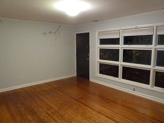 den with large picture window and original hardwoods