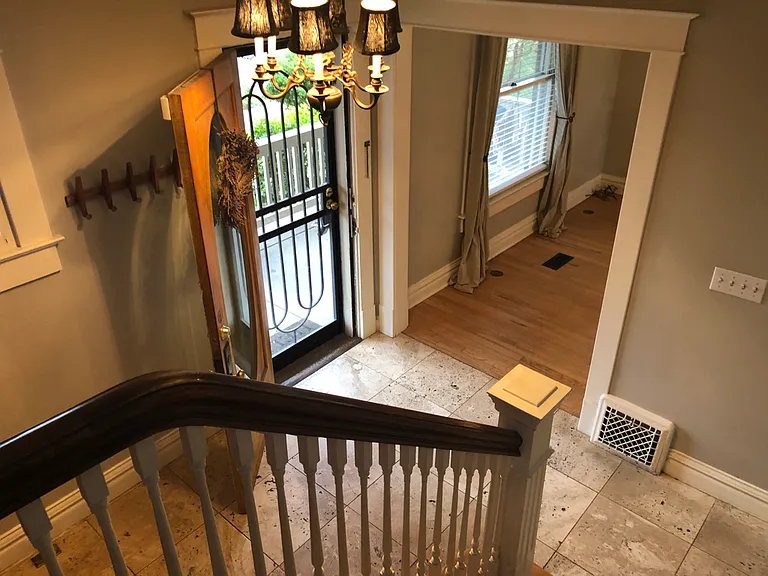 Staircase with downward view into entry