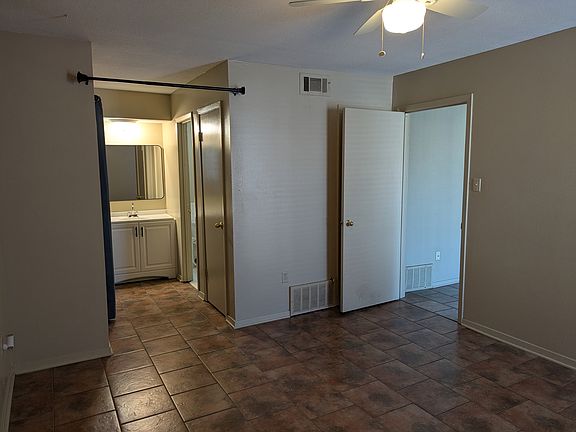 View of vanity area from the bedroom. The open door goes into the living room. To the right of the vanity is the bathroom and to the left is a large closet.