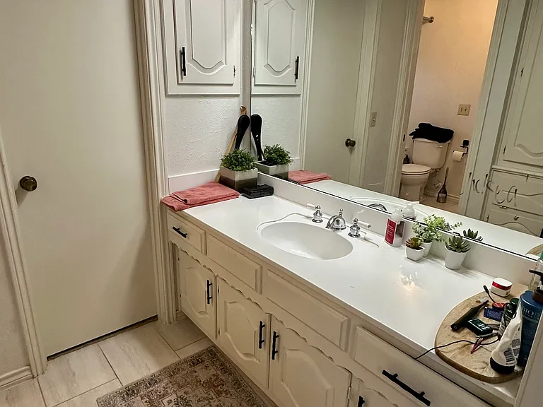 His and Hers primary bathroom with vanity and tile floors