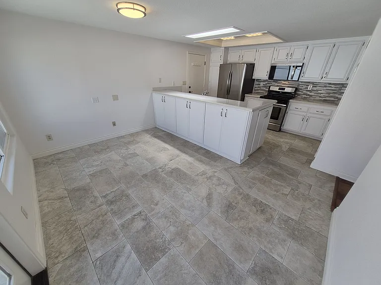Breakfast area with skylight and beautiful tile floors.