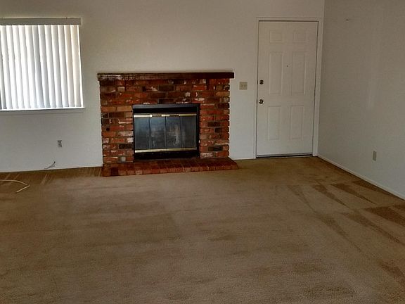 Living room with brick fireplace