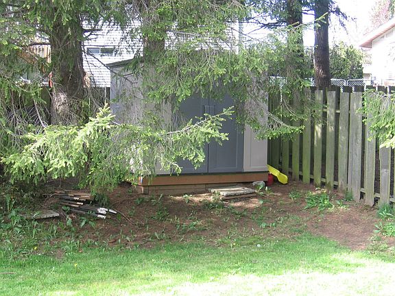 Private backyard with a shed ofr all your tools