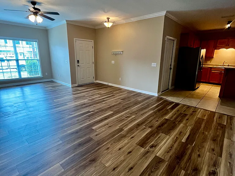 Spacious living room with a large front window allowing lots of natural light into the space.