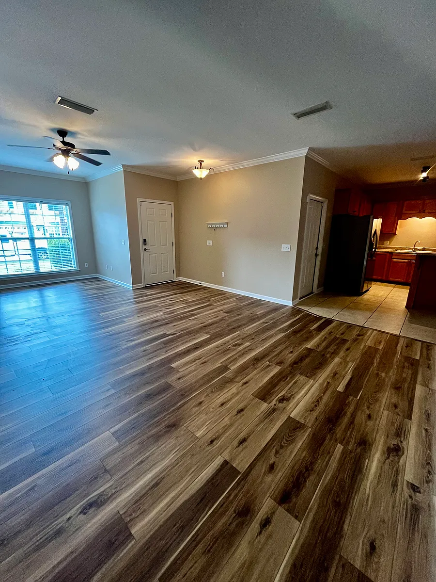 Spacious living room with a large front window allowing lots of natural light into the space. - 103 Whitney Ave