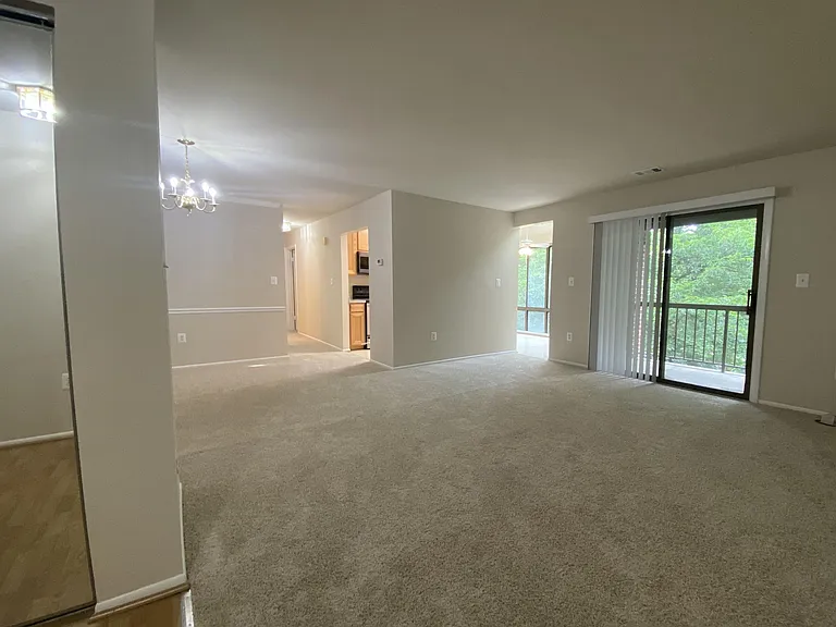 Living room, views into kitchen, balcony, and breakfast nook