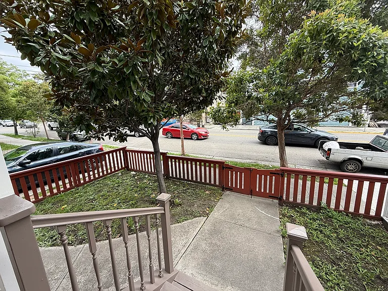 Gated front yard with mature tree
