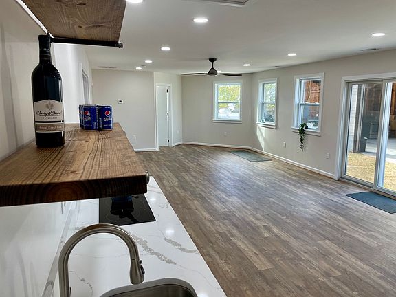 Lots of windows with great sun. Fully renovated in 2021. All new paint, floors, lights, custom blinds, kitchen, bath, heat, A/C, fans, cabinets, fridge, stove, windows...