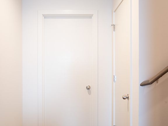 First floor hallway. Entrance to first bedroom, additional closet and stairway to second floor