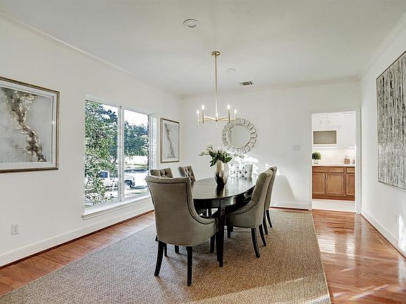 Formal dining room with large sunny view of front yard is almost 16 feet long.