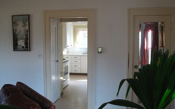 Short hall from living room to kitchen, closets on either side