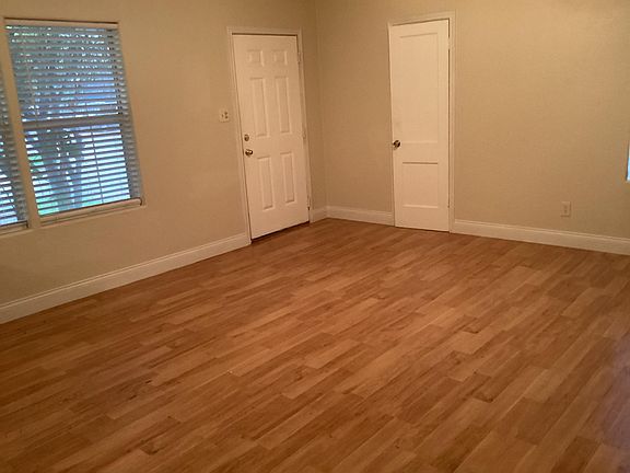 Living room, front door to left; storage/coat closet to right