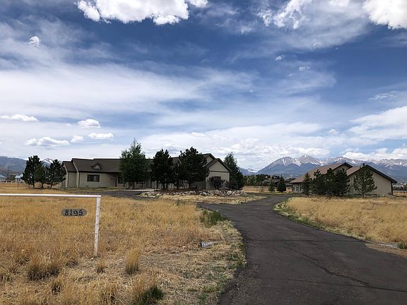 Driveway with house on left, barn on right