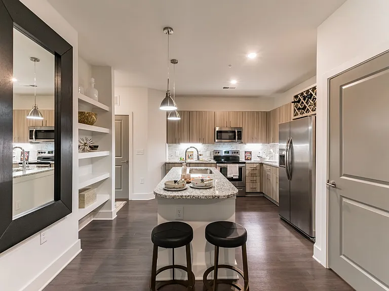 Kitchen Island with Two Barstools and built-in shelving on Kitchen Wall