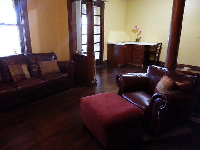 Open-concept living/dining room connects to spacious balcony running the length of the building.