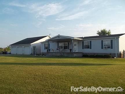 Home and Garage
						:
						The porch beckons you to take in the beautiful country setting.