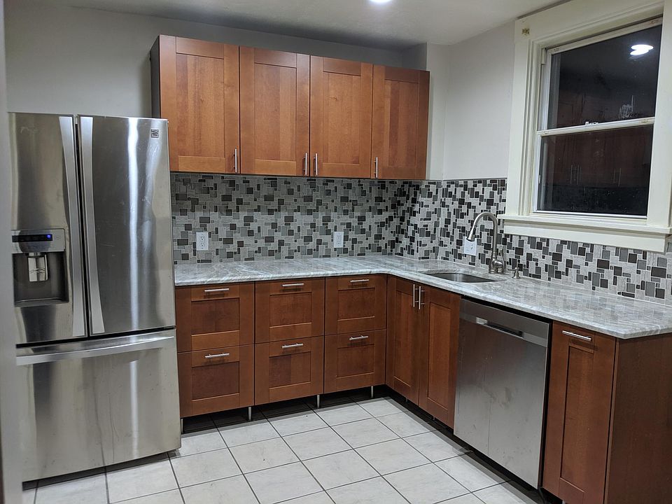 Ikea kitchen. Stainless steel fridge and dishwasher. Granite countertops. Undermount sink with garbage disposal and glass tile backsplash