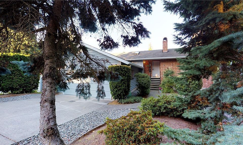 Beautiful blue fir and shrubbery rock garden in the front.