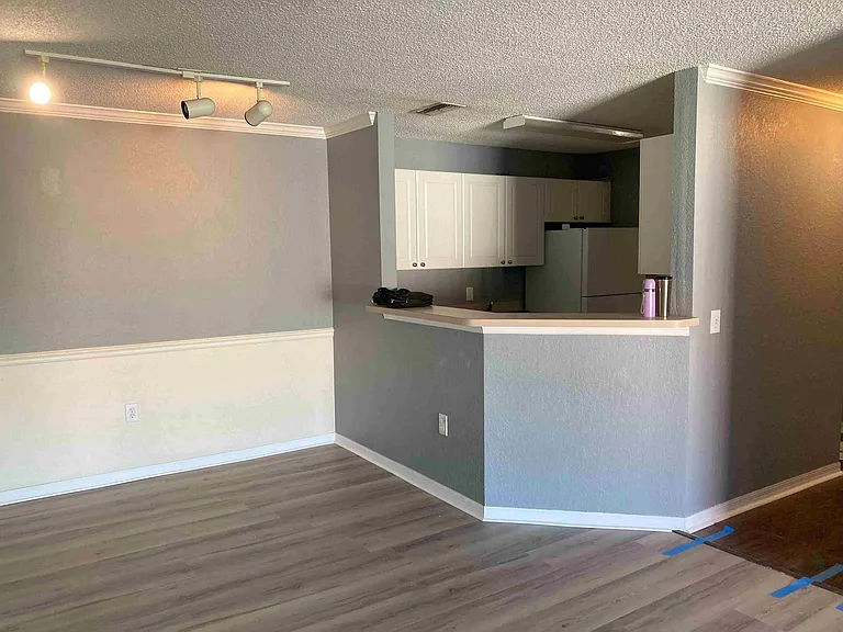 Dinner area with new installed Vinyl plank floor along with kitchen