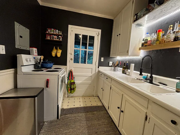 View of kitchen towards back door (small patio outside).