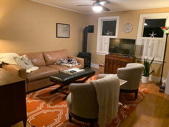 First floor living room w/TV gas stove and front door to the right