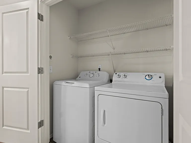 In-unit full-size washer and dryer with storage shelving at Port Landing at Fife in Fife, WA. In-unit full-size washer and dryer with storage shelving at Port Landing at Fife in Fife, WA.