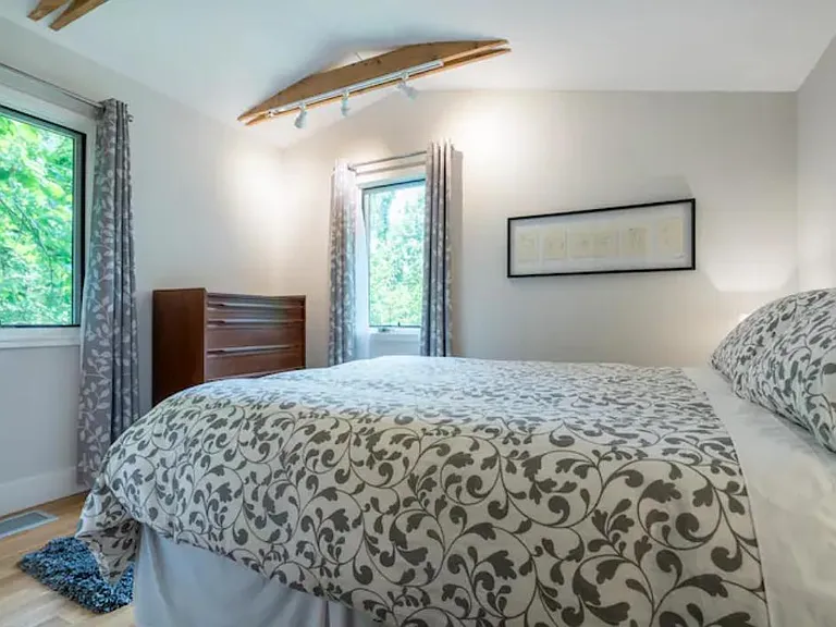Two windows allow lots of light and views of the lush backyard, while the light-blocking curtains provide privacy and quiet when you need it. NOTE: The dresser shown is NOT part of the current furnishings. Instead there is a gray, five drawer wood dresser