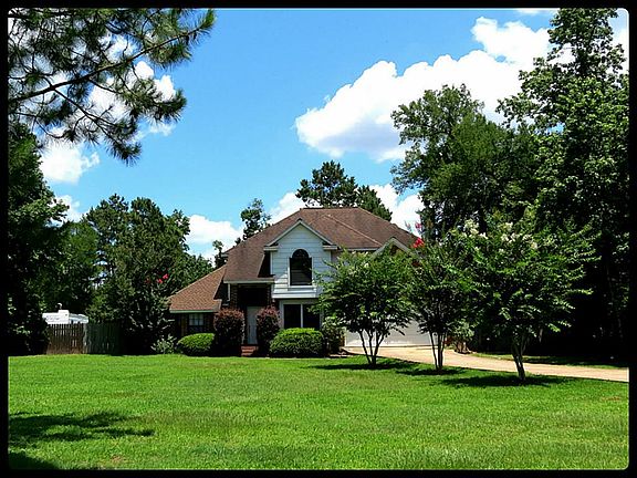 Large front yard and beautiful mature trees adds to the attractive curb appeal.
