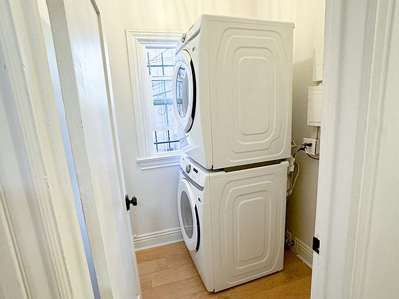 Laundry room with front loading stacked washer and dryer