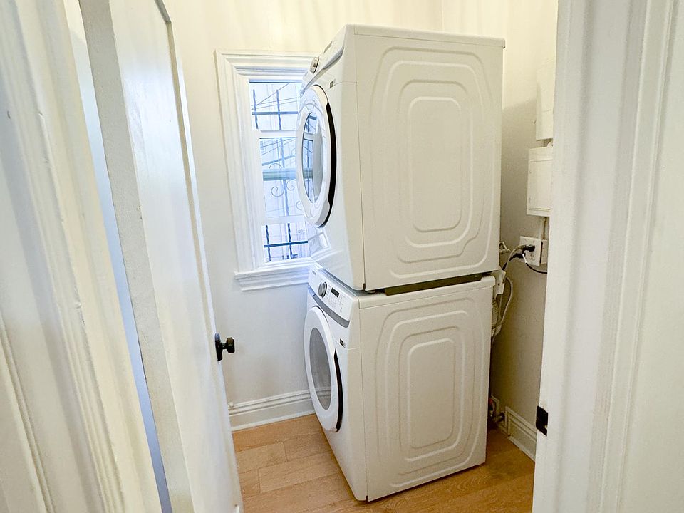 Laundry room with front loading stacked washer and dryer