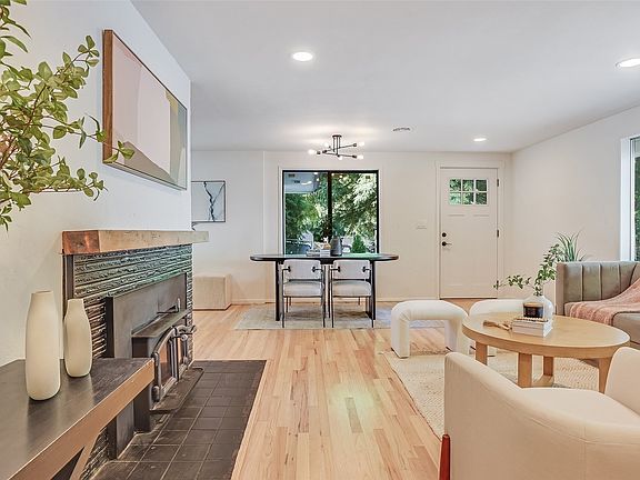 Beautiful hardwood flooring, cozy wood burning fireplace & an abundance of natural light.>