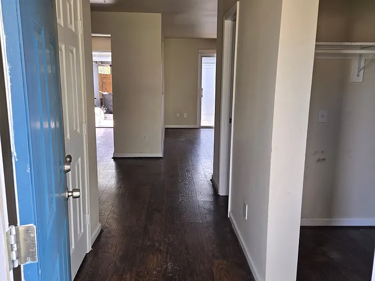 Front door entrance. Washer Dryer closet hook ups to the right as you head to the stairs. Rear kitchen door seen at other end of unit looking in.