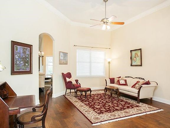Living room with crown molding & view to the pool