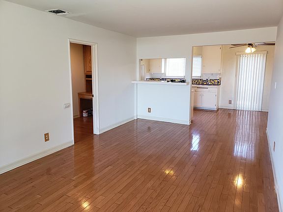View of living room looking into kitchen and hallway
