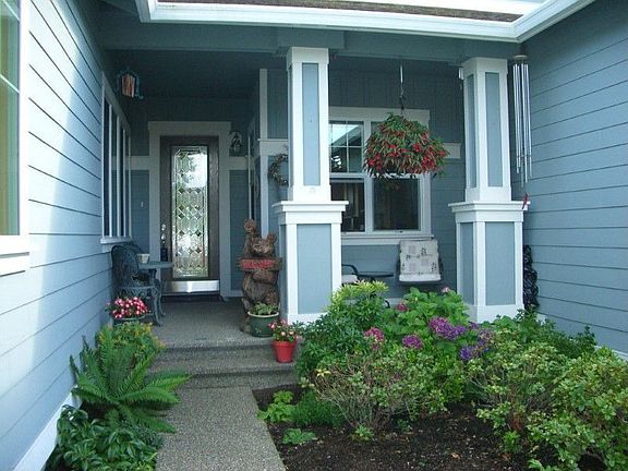 Enjoy your front porch patio under cover and nice garden space. Great place for a fountain.