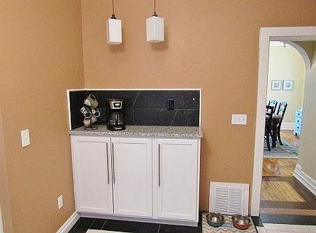 Tucked in the corner of the kitchen is a buffet for addition