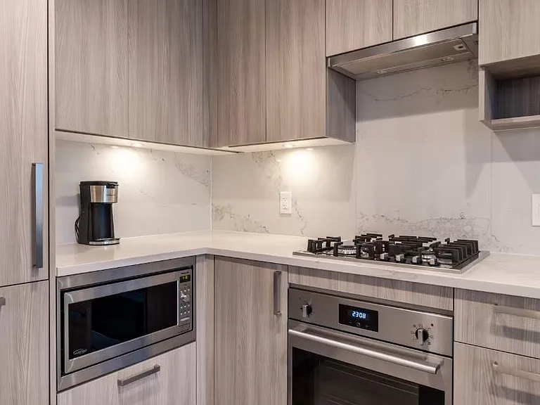 Bright and vibrant kitchen featuring modern appliances, including a coffeemaker, built-in microwave, and oven.
