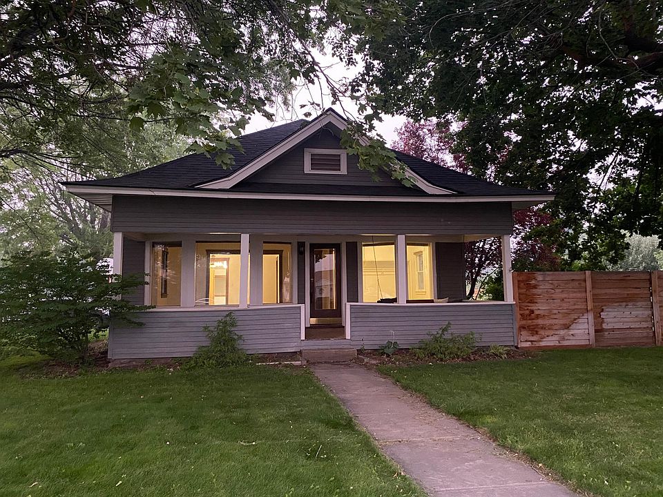 100 year old craftsman home surrounded by maple trees.