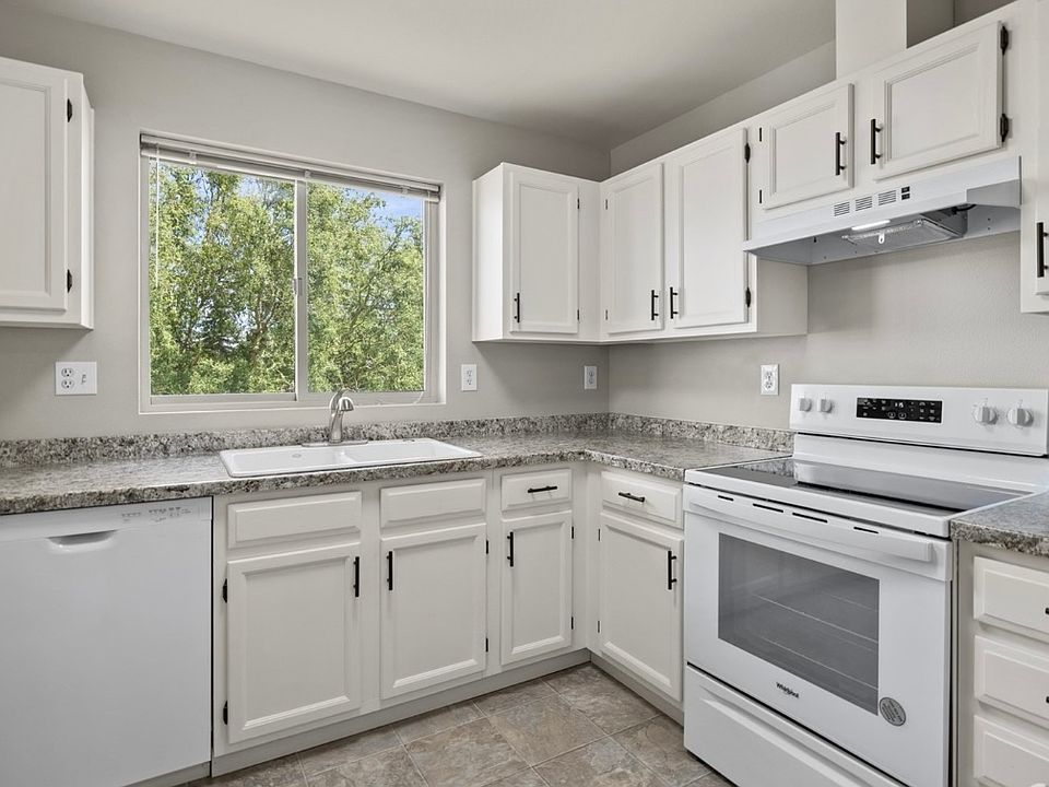 Bright sunny kitchen overlooking green space & trees