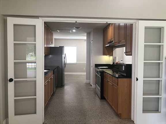 Original French doors to kitchen looking toward front of house