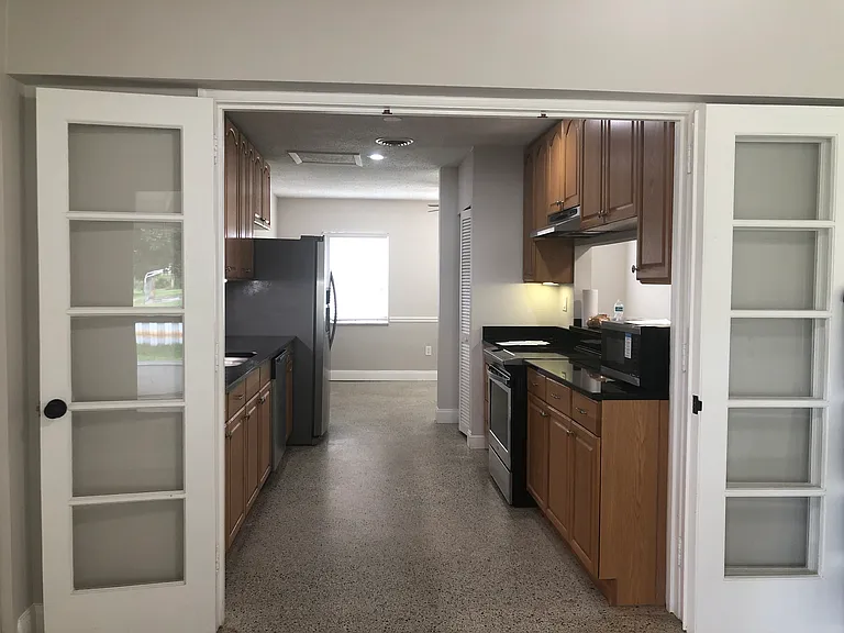 Original French doors to kitchen looking toward front of house
