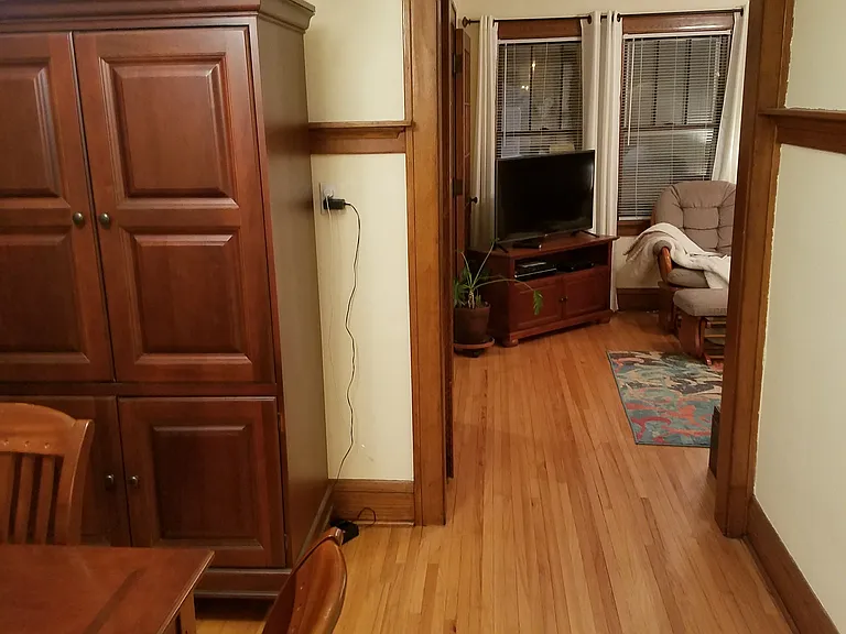 Reverse of dining room looking north to living room. Dining room has plate rail