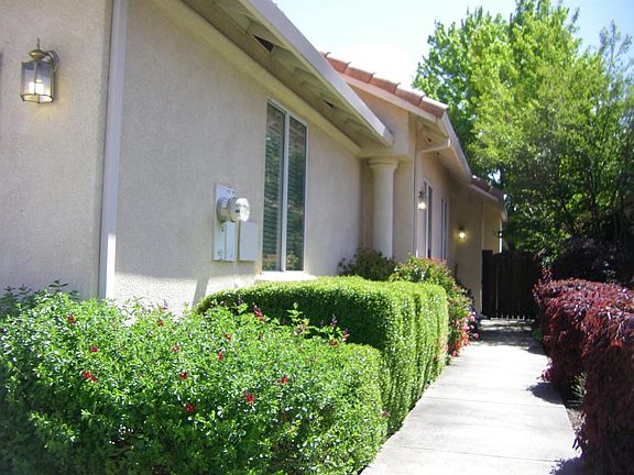 Entry is surrounded with gardens and flowers.