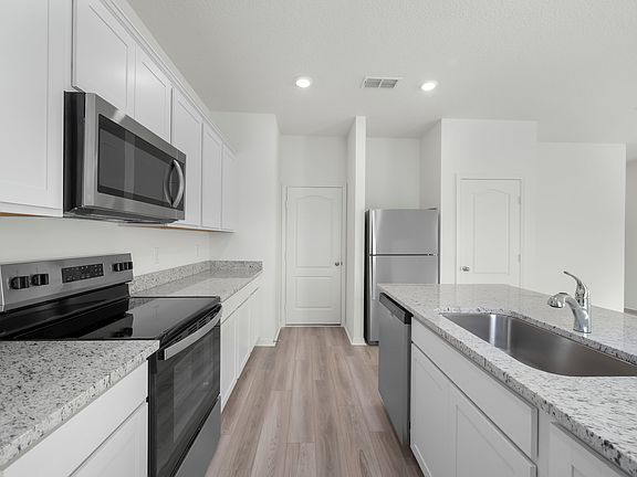 The kitchen is filled with stainless steel appliances